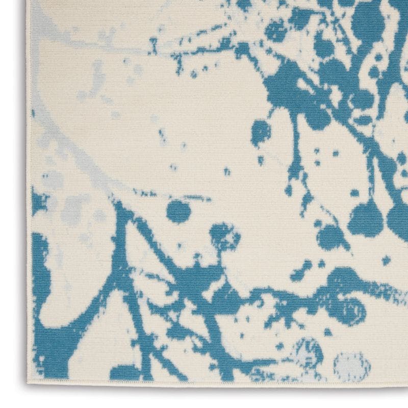 Ivory and Blue Abstract Synthetic 4' x 6' Easy-Care Area Rug