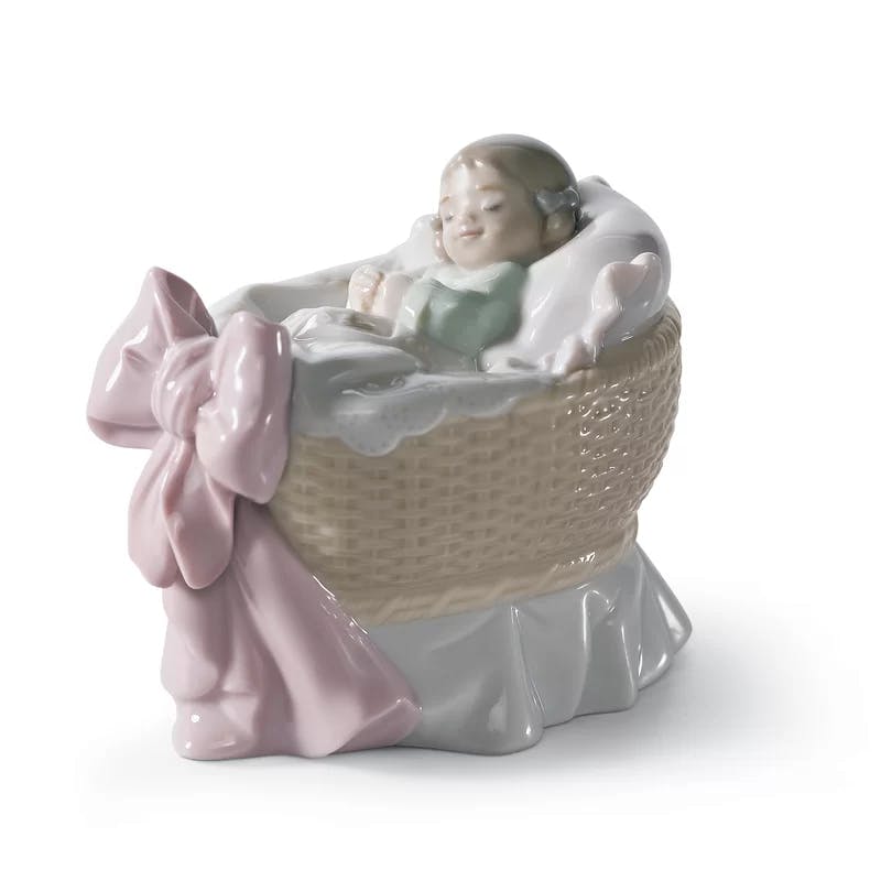 Glossy Porcelain Newborn Girl Bassinet Figurine with Pink Bow