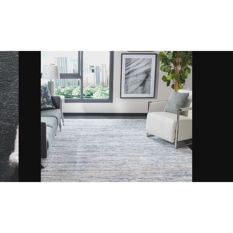 Ivory and Blue Abstract Synthetic 4' x 6' Easy-Care Area Rug